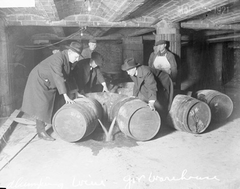 Prohibition agents destroying barrels of alcohol